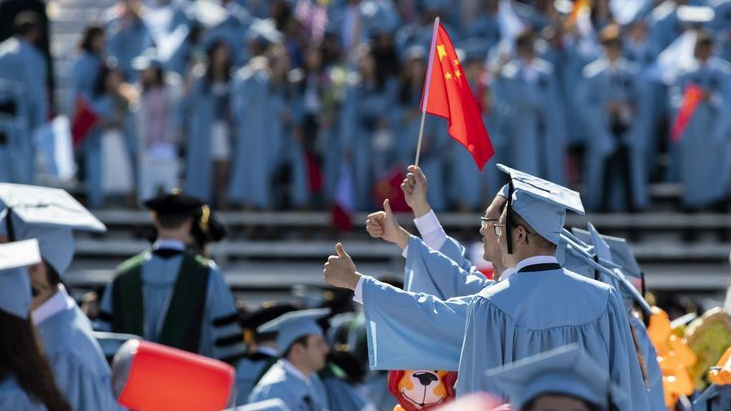 Graduate students from China pose for photos before the Columbia University Commencement ceremony in New York, the U.S., May 22, 2019. /Xinhua