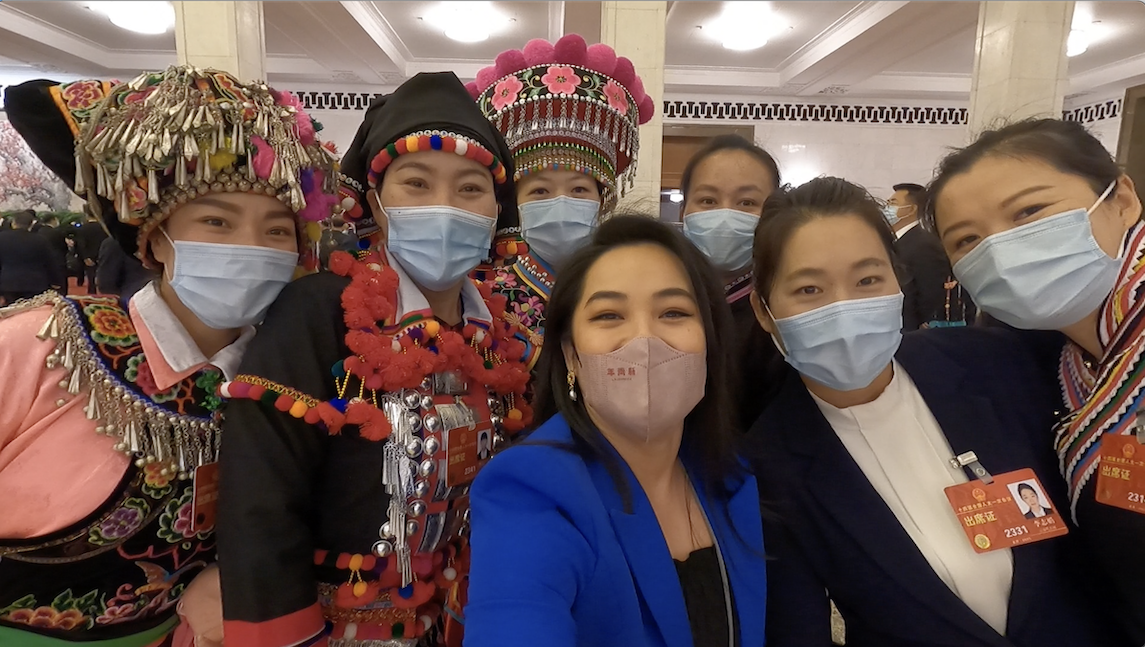 Deputies from multiple ethnic groups from Yunnan Province take a selfie with CGTN reporter Li Jingjing after finishing an interview at the Great Hall of the People in Beijing. /CGTN