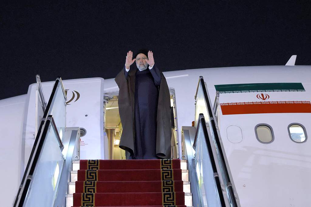 Iranian President Ebrahim Raisi waves to his honor guard during the farewell ceremony as he departs from the Mehrabad International Airport in Tehran, Iran, for a visit to China, February 13, 2023. /CFP