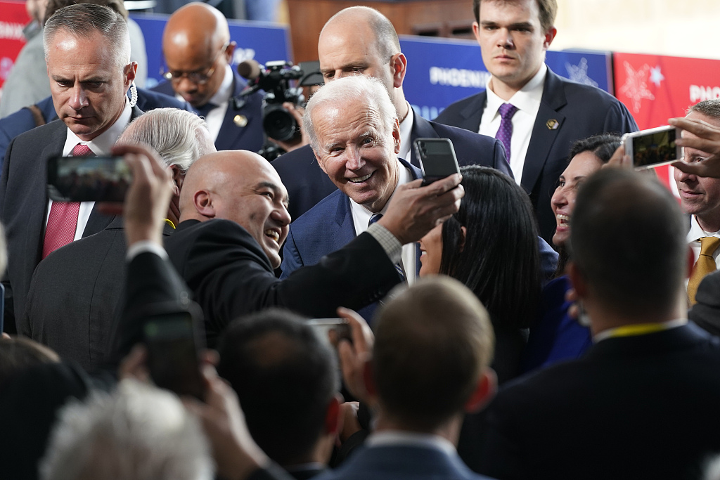 U.S. President Joe Biden takes photos with guests after touring the building site for a new chip plant of Taiwan-based TSMC, in Phoenix, Arizona, U.S., December 6, 2022. /CFP