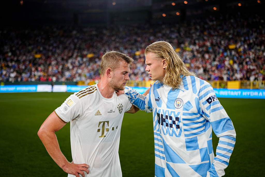 2022 年 7 月 23 日，拜仁慕尼黑队的 Matthijs de Ligt（左）和曼城队的 Erling Haaland 在季前赛友谊赛后在威斯康星州格林湾的 Lambeau 球场相互拥抱。/CFP