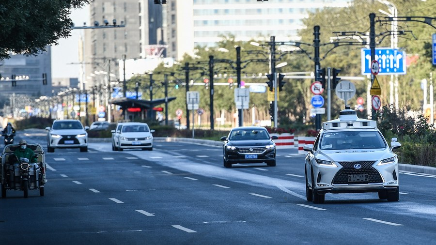 An autonomous vehicle (1st R) is in driverless test on a road in Yizhuang of Beijing, capital of China, October 19, 2021. /Xinhua