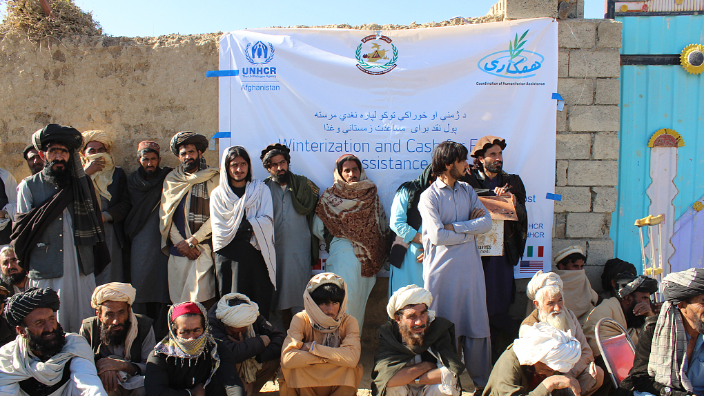 People wait as UNHCR distrubutes cash assistance to 8,027 families of Waziristan refugees in the Gulan camp in Khost province, Afghanistan, December 9, 2021. /CFP