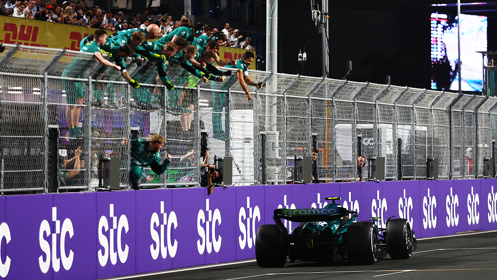 Fernando Alonso driving the race car passes his team celebrating on the pit wall during the F1 Grand Prix of Saudi Arabia in Jeddah, Saudi Arabia, March 19, 2023. /CFP