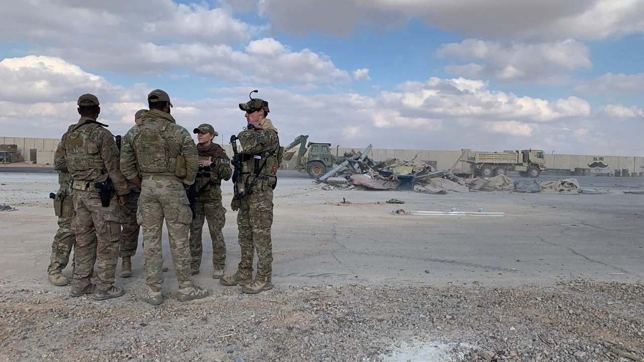 U.S. soldiers stand while bulldozers clear rubble and debris at Ain al-Asad air base in Anbar, Iraq, January 13, 2020. /AP