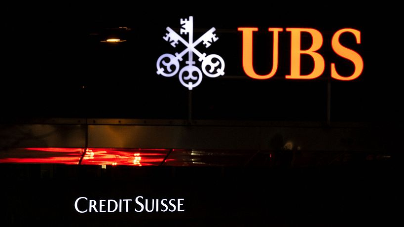 A logo of Credit Suisse bank is seen behind a logo of Swiss bank UBS in Zurich, Switzerland, March 18, 2023. /CFP