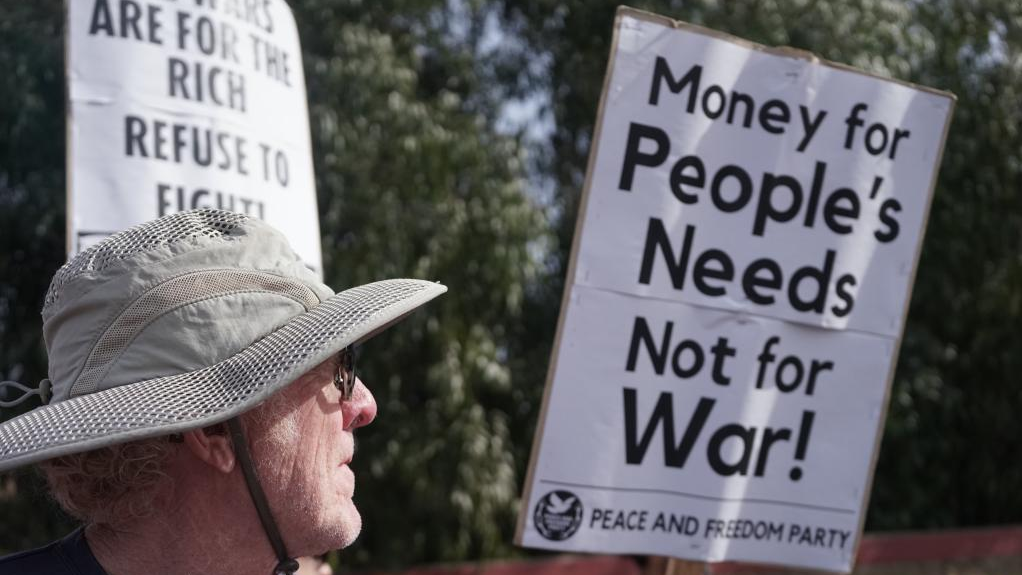 A protester is seen in front of Marine Corps Air Station Miramar, California, the United States, March 18, 2023. Anti-war organizations held rallies in the run-up to the 20th anniversary of the U.S. invasion of Iraq. /Xinhua
