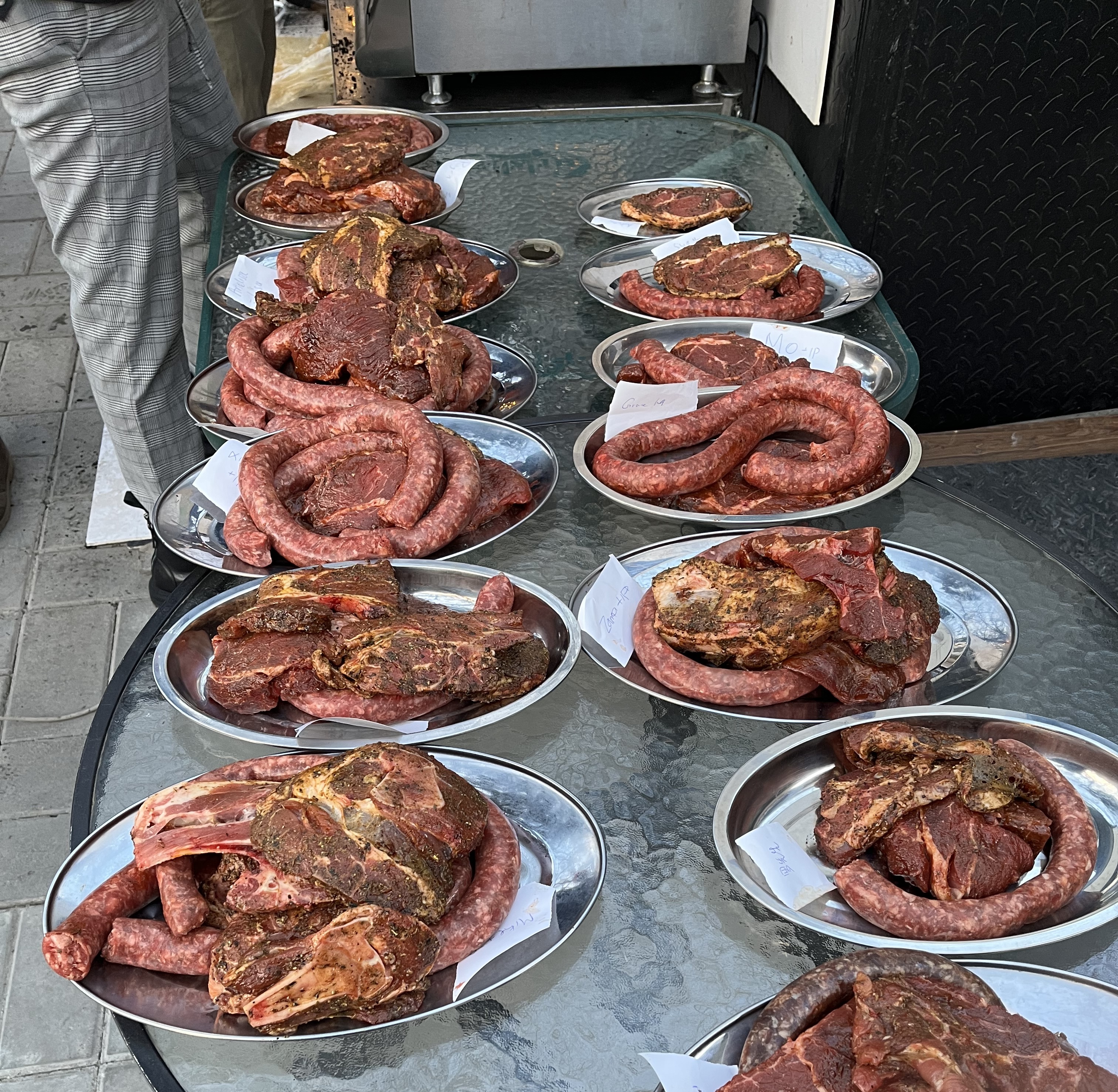 Cuts of meat and boerewors – spicy sausages from South Africa - are ready to go on a grill in Beijing. /CGTN 