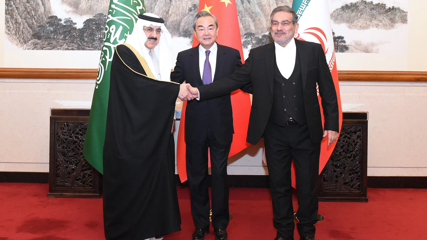 Admiral Ali Shamkhani (R), Secretary of the Supreme National Security Council of Iran, shakes hands with Musaad bin Mohammed Al-Aiban (L), Saudi Arabia's Minister of State, as Wang Yi (C), director of the Office of the Foreign Affairs Commission of the Communist Party of China Central Committee, looks on for a photo during a meeting in Beijing, China, March 10, 2023. /Xinhua
