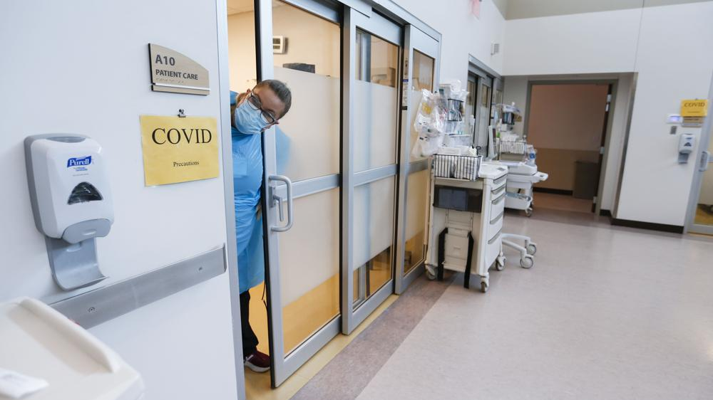 In this file photo from July 16, 2021, a nurse sticks her head out of the room of a COVID-19 patient in the CoxHealth Emergency Department in Springfield, Missouri. The COVID-19 pandemic has created a nurse staffing crisis that is forcing many U.S. hospitals to pay top dollar to get the help they need to handle the rush of patients this summer. /AP 