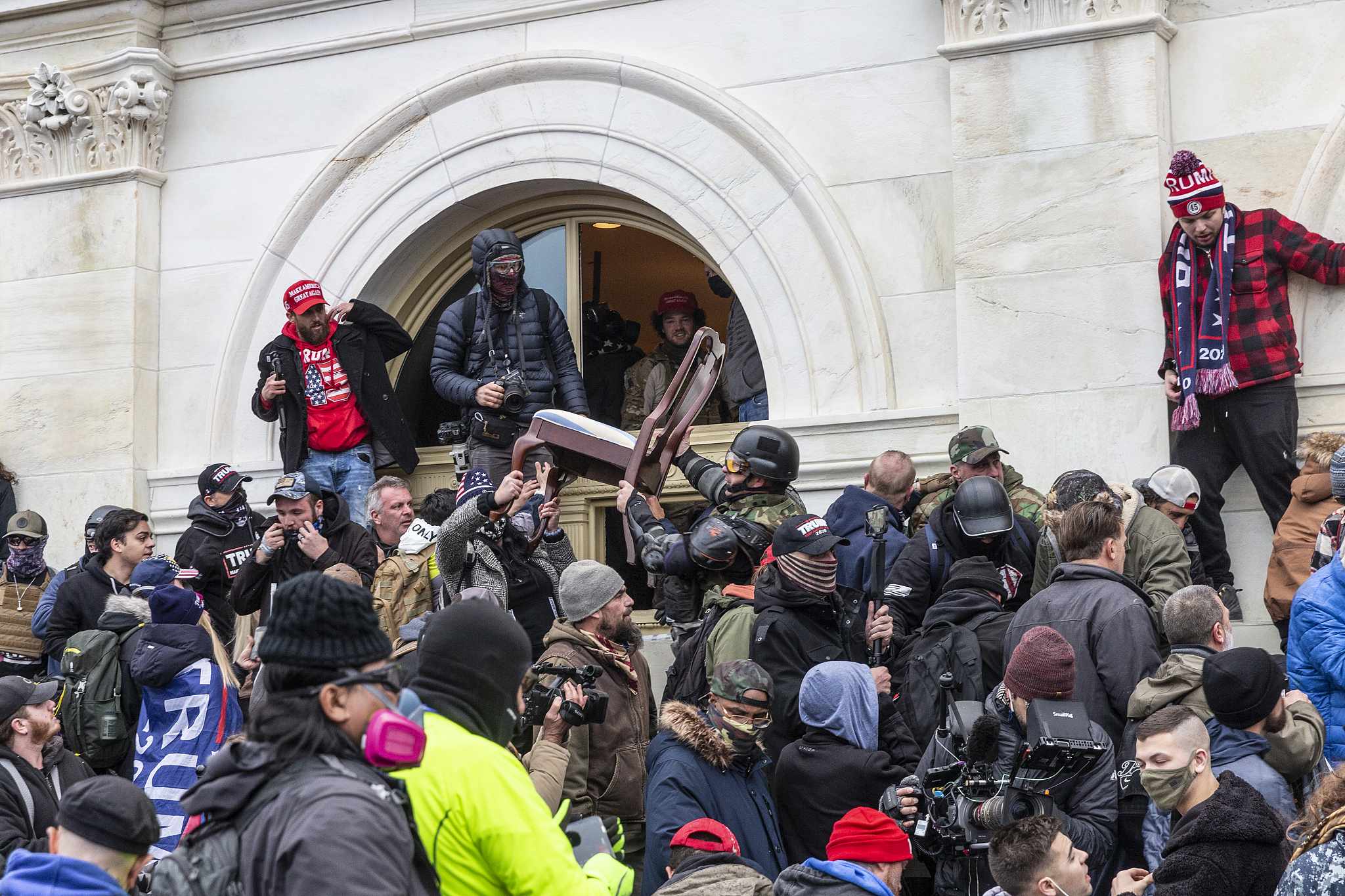 Supporters of former U.S. President Donald Trump breached through the windows into Capitol building and threw furniture out in Washington, D.C., U.S., January 6, 2021. /VCG