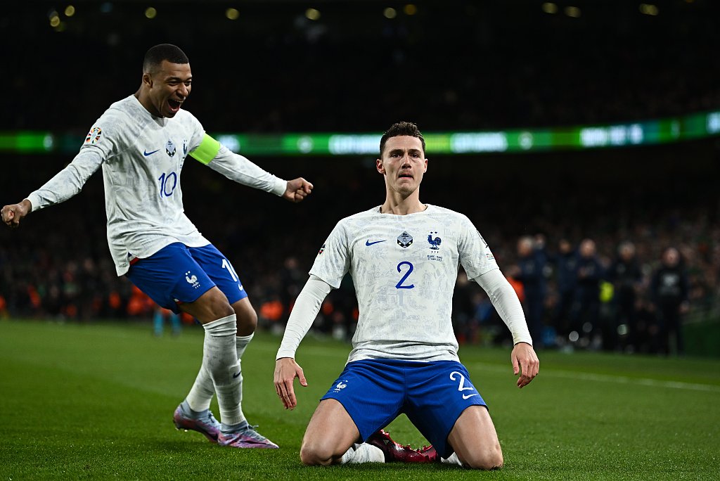 Benjamin Pavard (#2) of France celebrates with teammate Kylian Mbappe after scoring a goal against Ireland during their Euro 2024 qualifier at Aviva Stadium in Dublin, Ireland, March 27, 2023. /CFP 
