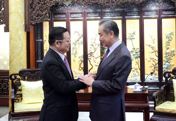 Wang Yi (R), a member of the Political Bureau of the Communist Party of China (CPC) Central Committee and director of the Office of the Foreign Affairs Commission of the CPC Central Committee, shakes hands with Kao Kim Hourn, secretary-general of the Association of Southeast Asian Nations, in Beijing, China, March 27, 2023. /Xinhua