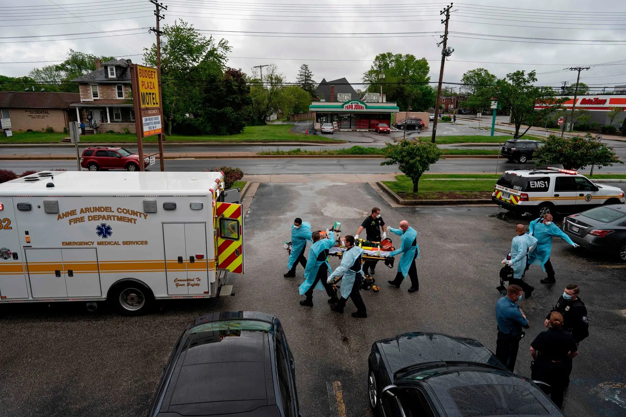 Firefighters and paramedics with Anne Arundel County Fire Department transport a patient after responding to a call for a cardiac arrest as a result of a drug overdose in Brooklyn, New York, the U.S., May 6, 2020. Alex Edelman/AFP via Getty Images