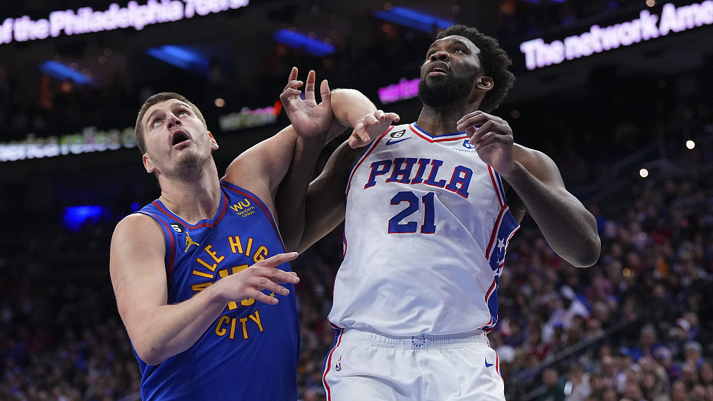 Nikola Jokic (L) of the Denver Nuggets and Joel Embiid of the Philadelphia 76ers tussle for a rebound in the game at the Wells Fargo Center in Philadelphia, Pennsylvania, January 28, 2023. /CFP