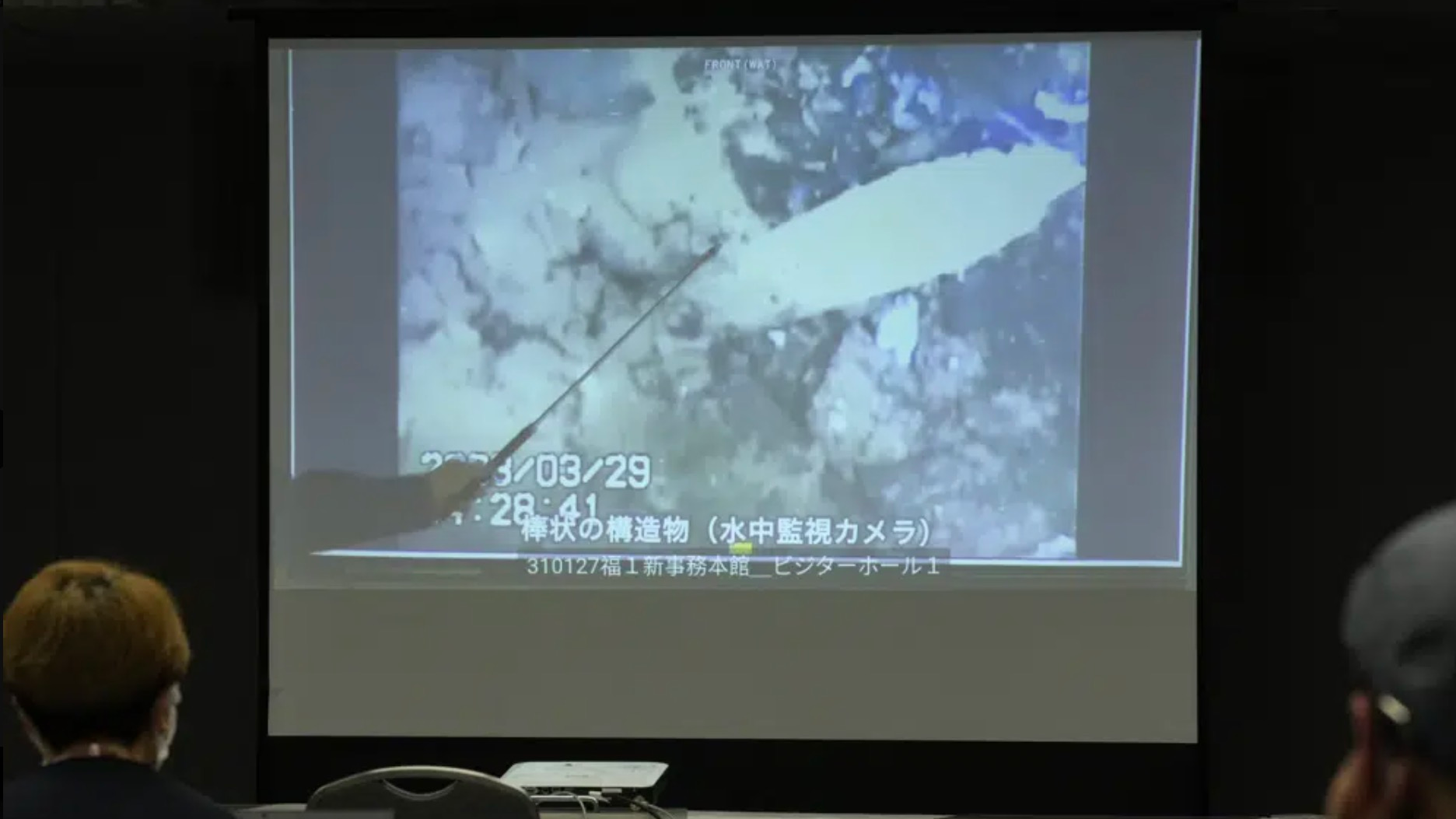 A spokesperson for the TEPCO shows photos captured by a robotic probe inside one of the three melted reactors at the tsunami-wrecked Fukushima nuclear power plant, during a news conference at the TEPCO headquarters in Tokyo, Japan, April 4, 2023. /CFP
