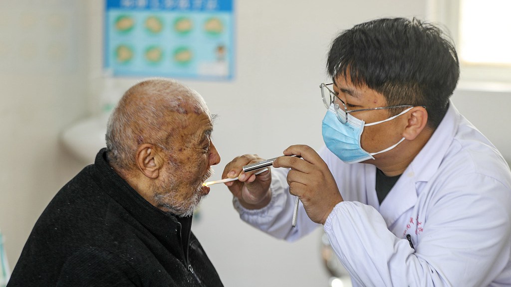 A medical worker conducts a free medical check for a local resident, Taizhou City, east China's Jiangsu Province, April 7, 2023. /CFP