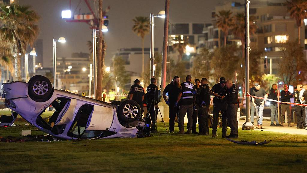 Israeli police gather next to an overturned car at the site of an attack in Tel Aviv on April 7, 2023. /CFP