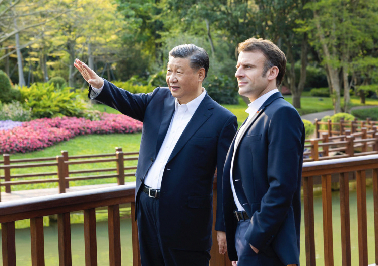 Chinese President Xi Jinping and French President Emmanuel Macron stroll through the Pine Garden, chatting and stopping at times to enjoy the unique scenery of the southern Chinese garden, in Guangzhou, south China's Guangdong Province, April 7, 2023. /Xinhua