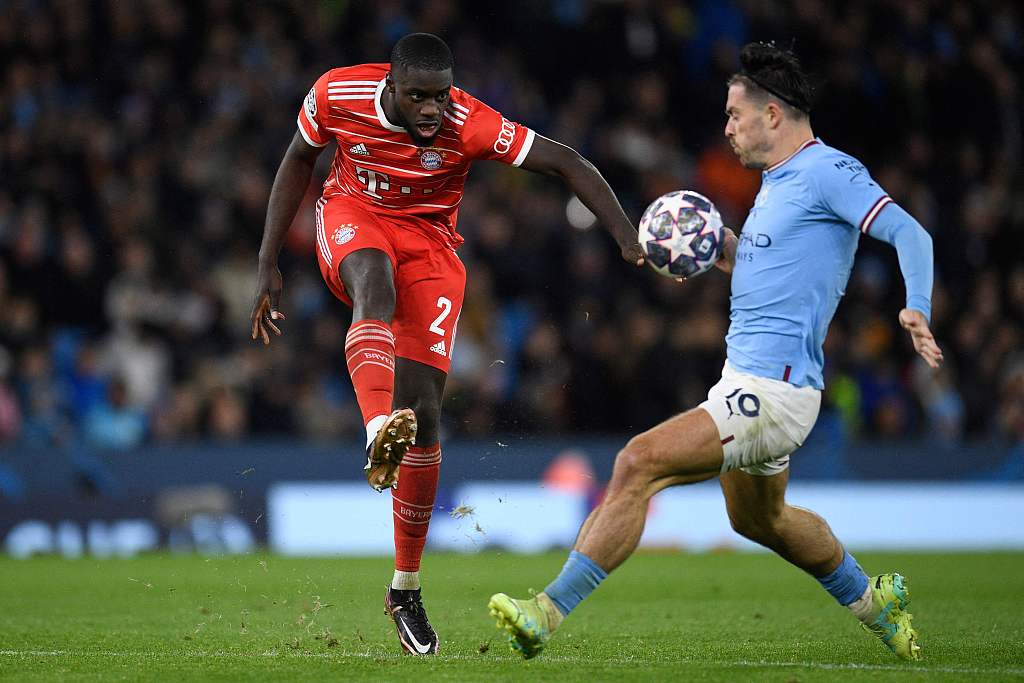 Dayot Upamecano (L) of Bayern Munich tries to clear the ball in the first-leg game of the UEFA Champions League quarterfinals against Manchester City at the Etihad Stadium in Manchester, England, April 11, 2023. /CFP