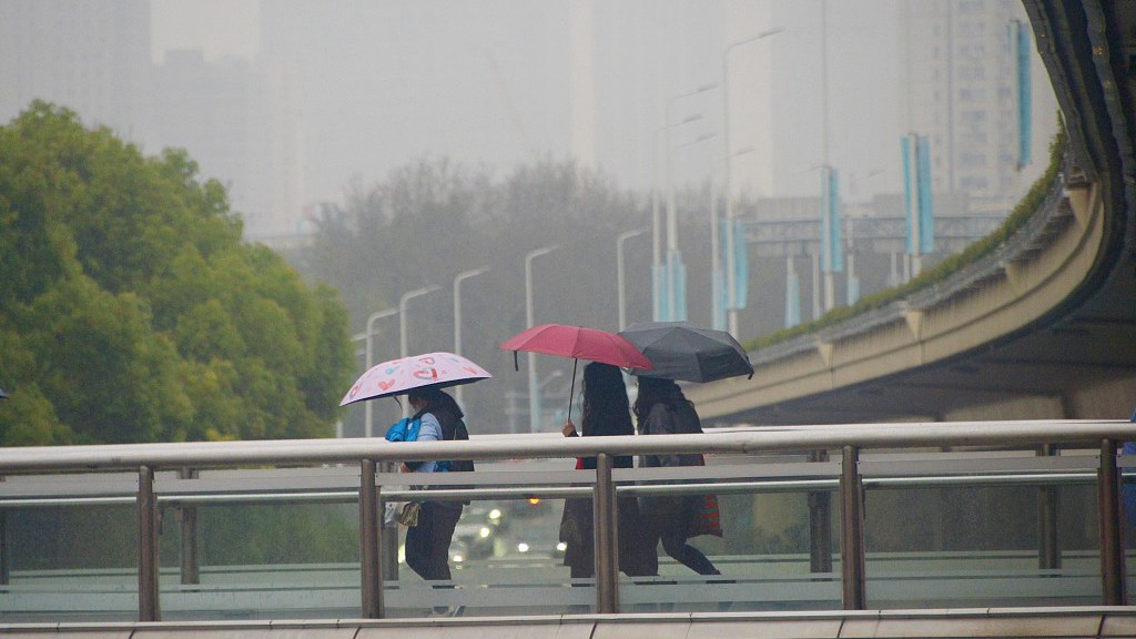 Residents holding umbrellas walk in the rain, Shanghai, China, March 22, 2023. /CFP