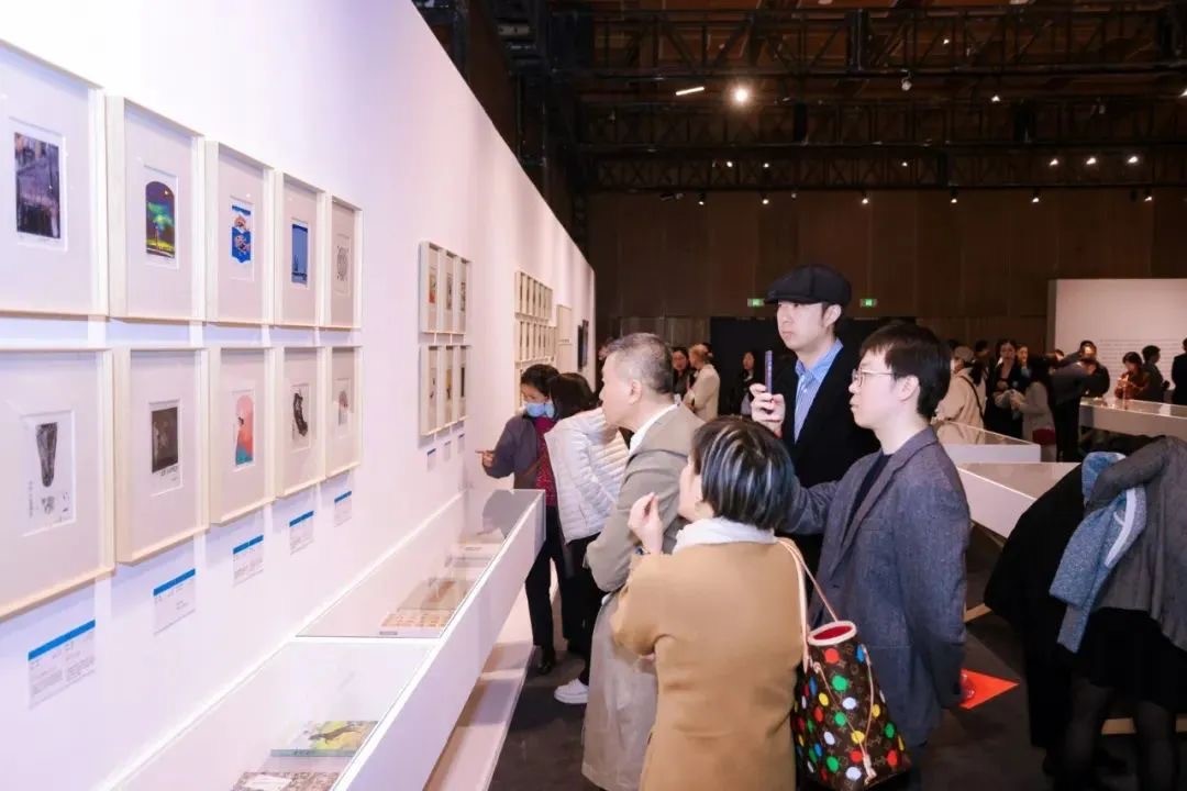 Visitors look at bookplates on display at the Guardian Art Book Fair. / Guardian Press