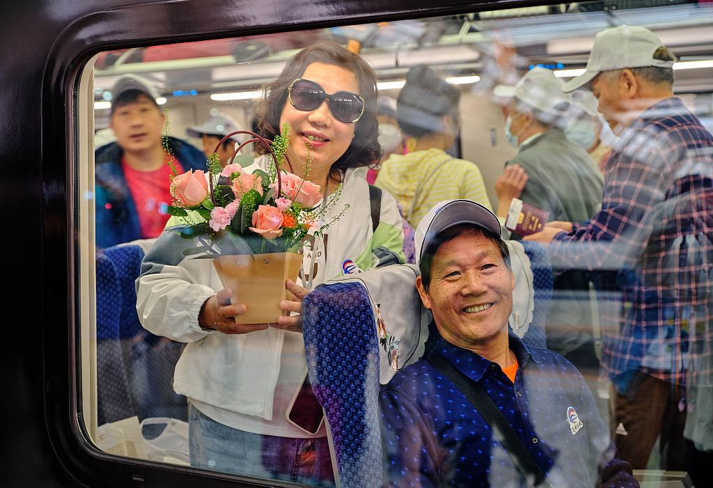 Passengers of the first cross-border passenger train of China-Laos Railway which departs from Kunming, capital of southwest China's Yunnan Province, heading for the Lao capital Vientiane, April 13, 2023. /CFP