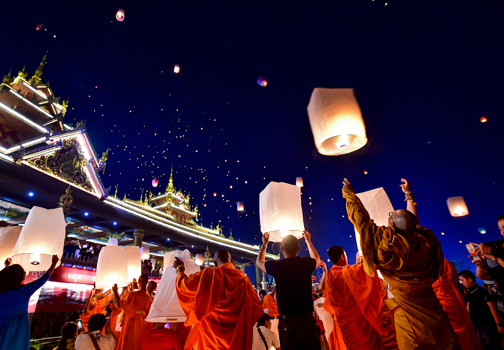 Monks send burning lanterns into the sky along the Lancang River as a part of the celebrations for the annual Water Splashing Festival. /CFP