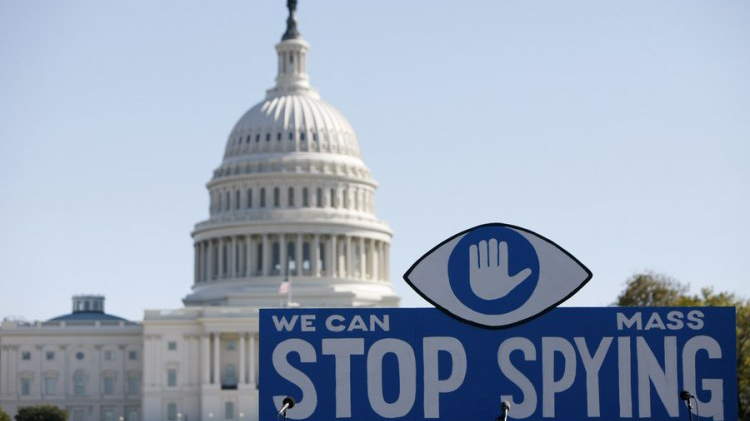 A huge slogan board stands in front of the U.S. Capitol building during a protest against government surveillance in Washington, D.C., U.S., October 26, 2013. /Xinhua