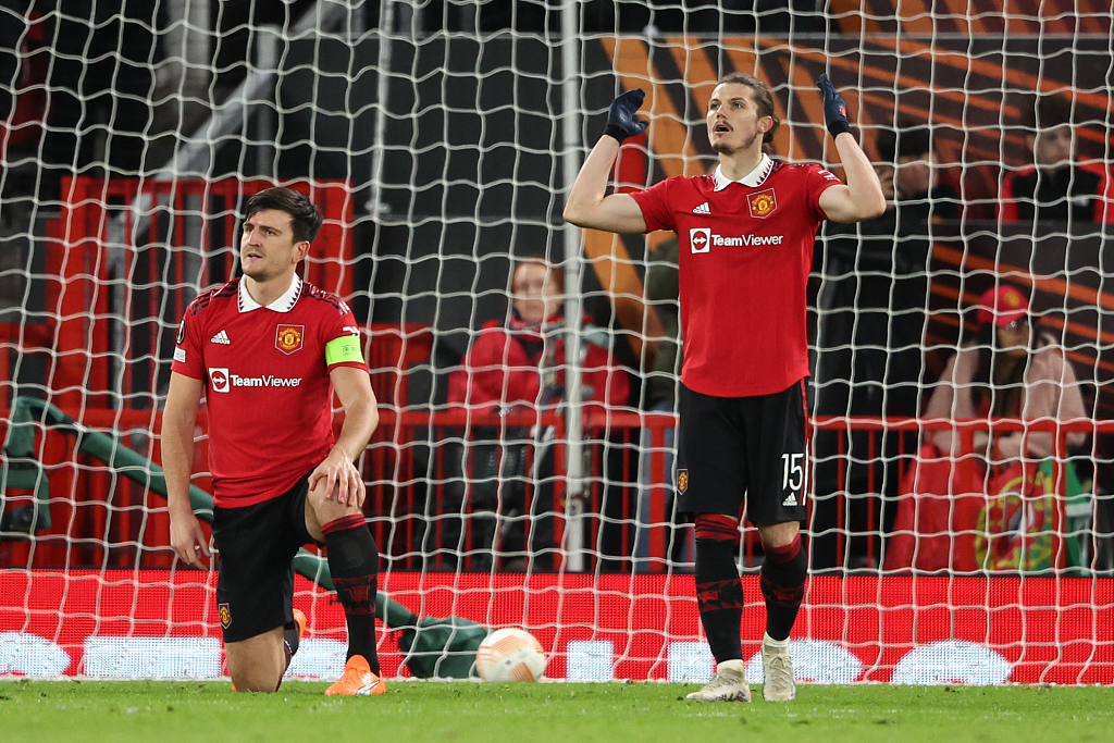 Manchester United players react after conceding an own goal during their Europa League clash with Sevilla at Old Trafford in Manchester, England, April 13, 2023. /CFP