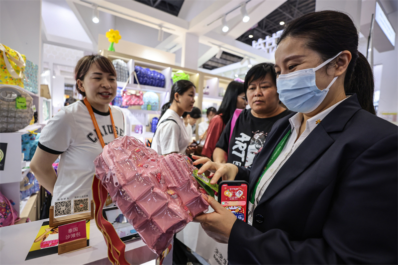 Visitors learn about a beach bag made in Thailand at the third China International Consumer Products Expo (CICPE) in Haikou, south China's Hainan Province, April 12, 2023. /Xinhua