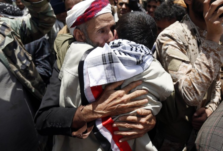A father hugs his son who was released in a prisoner swap at Sanaa Airport in Sanaa, Yemen, April 14, 2023. /Xinhua