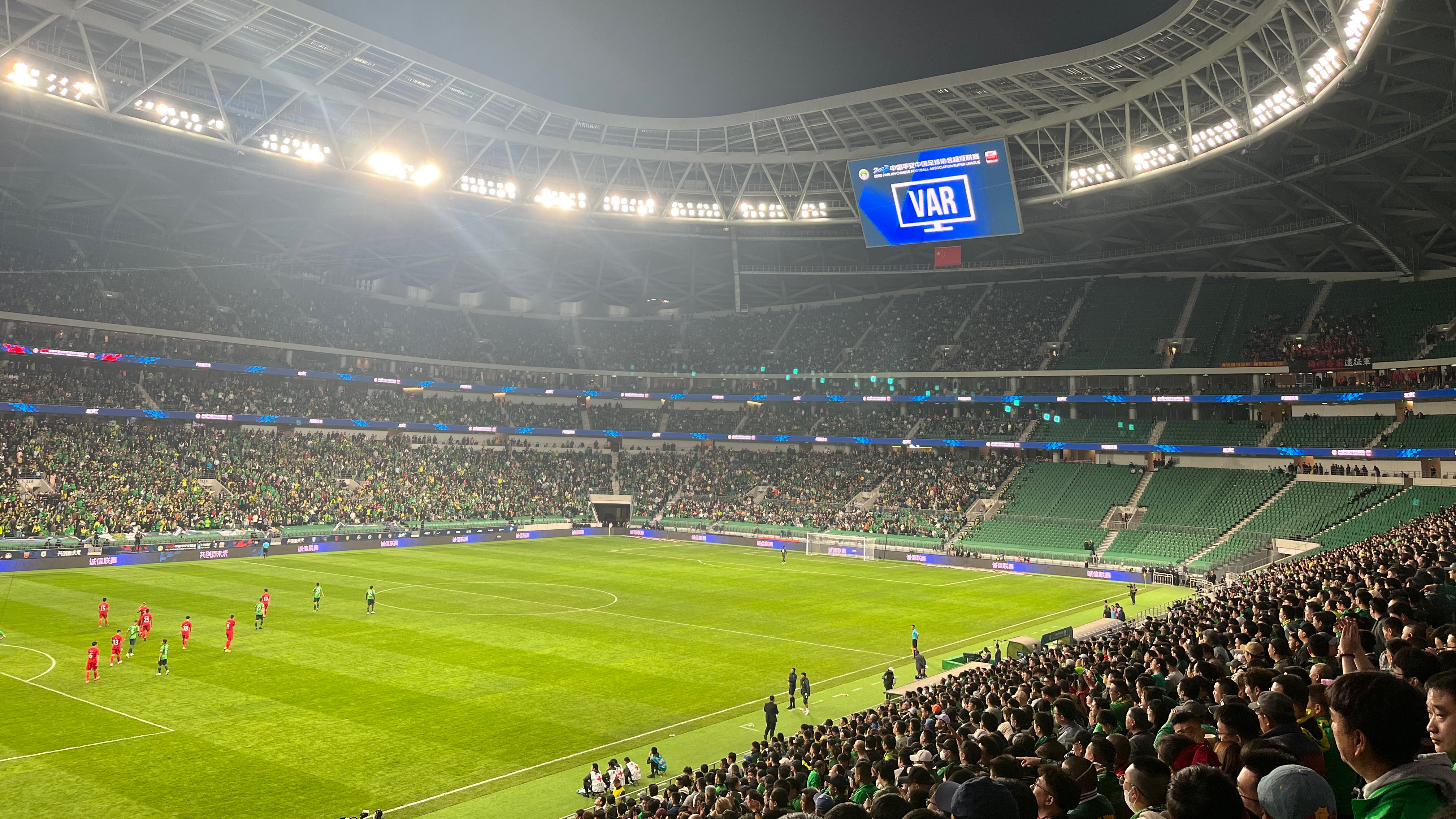 The LED board shows the VAR check for a possible penalty during Beijing Guoan's Chinese Super League clash with Meizhou Hakka at the new Workers' Stadium in Beijing, China, April 15, 2023. /CGTN