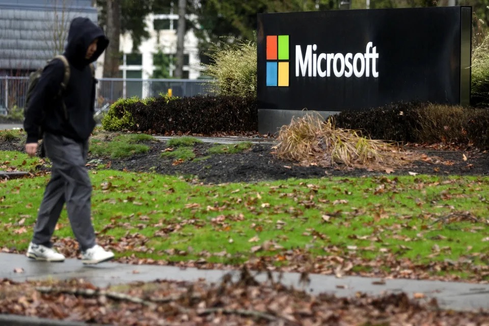A person walks past Microsoft signage at the headquarters in Redmond, Washington, U.S., January 18, 2023. /Reuters