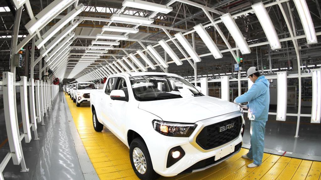 A worker inspects a vehicle before it rolls off the production line at an automobile manufacturing factory in Qingdao, east China's Shandong Province, January 14, 2023. /Xinhua