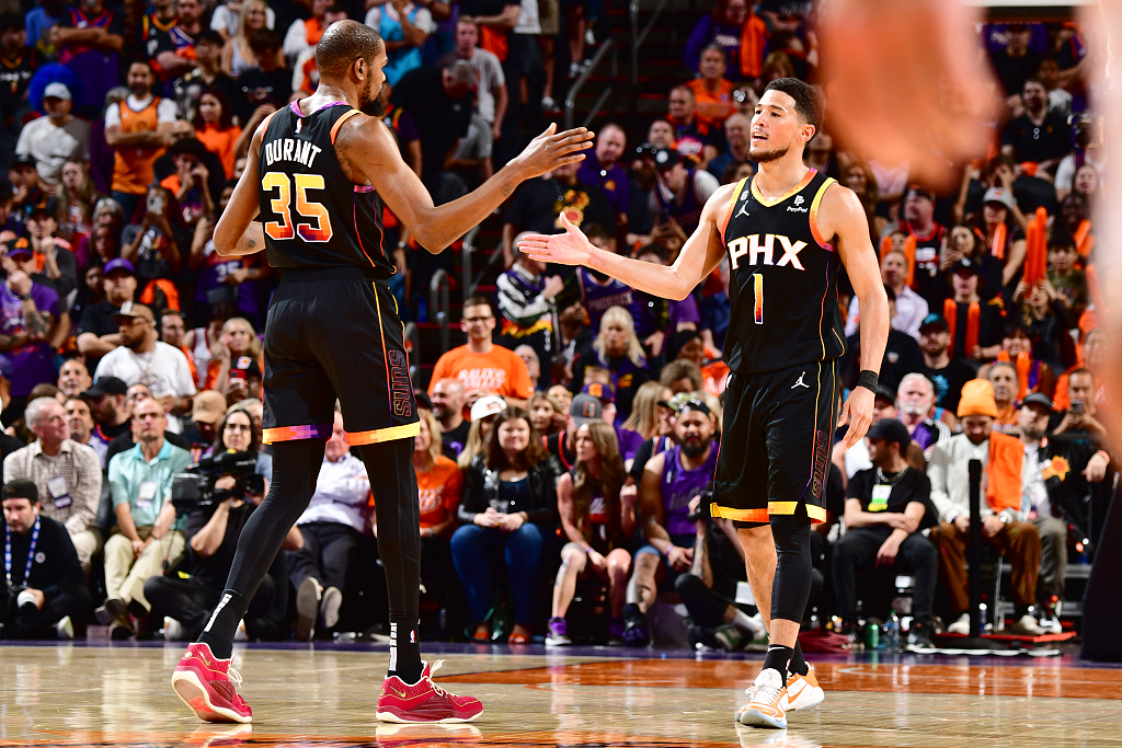Devin Booker (#1) and Kevin Durant of the Phoenix Suns high five each other in Game 5 of the NBA Western Conference first-round playoffs at the Footprint Center in Phoenix, Arizona, April 25, 2023. /CFP