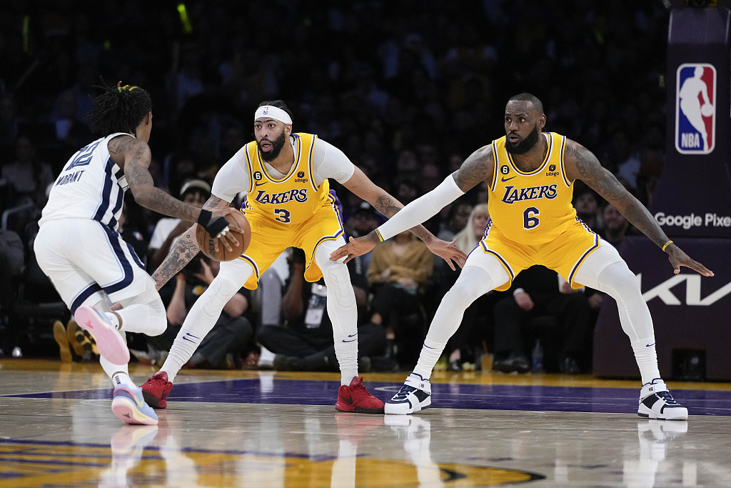 LeBron James (#6) and Anthony Davis (#3) of the Los Angeles Lakers guard Ja Morant of the Memphis Grizzlies in Game 6 of the NBA Western Conference first-round playoffs at Crypto.com Arena in Los Angeles, California, April 28, 2023. /CFP
