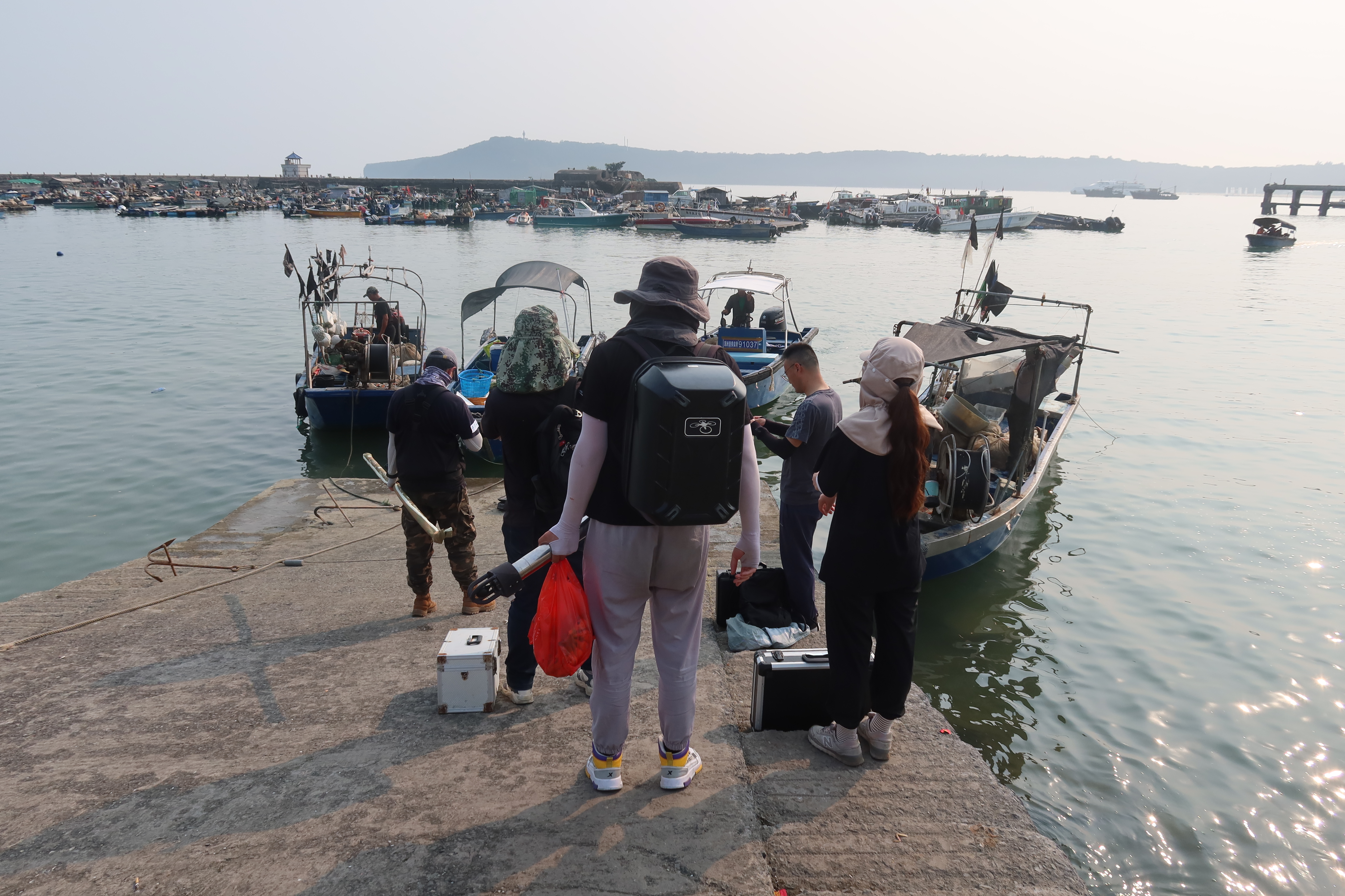 Professor Chen Bingyao and his team at Nanjing Normal University prepare to go to the sea at the port of Weizhou Island, south China's Guangxi Zhuang Autonomous Region. 