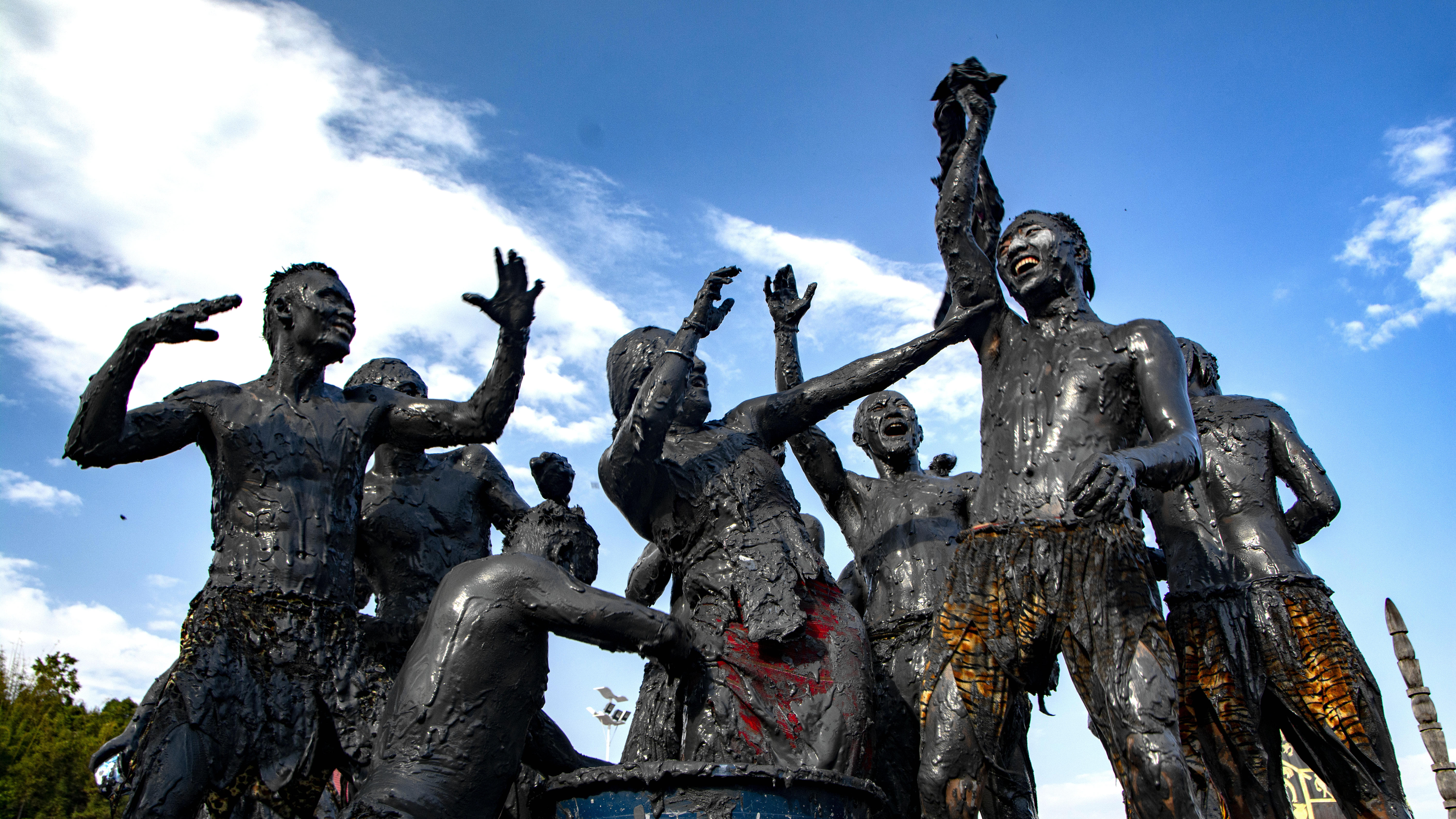 Watch: Join the carnival in SW China to paint each other black!