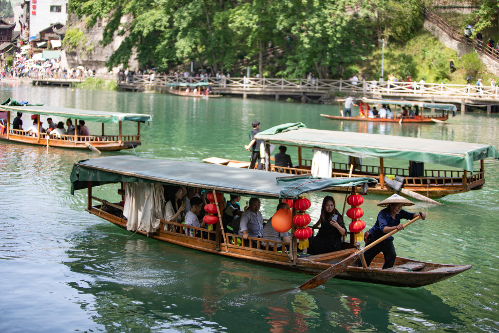 Tourists soak up the stunning scenery and unique folk culture at Hong'an Ancient Town in Xiushan Tujia and Miao Autonomous County, southwest China's Chongqing Municipality, on April 30, 2023. /CFP