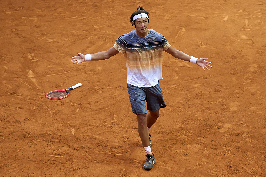 Zhang Zhizhen of China celebrates his win over Taylor Fritz of the United States during their men's singles fourth round match at the Madrid Open, Spain, May 2, 2023. /CFP
