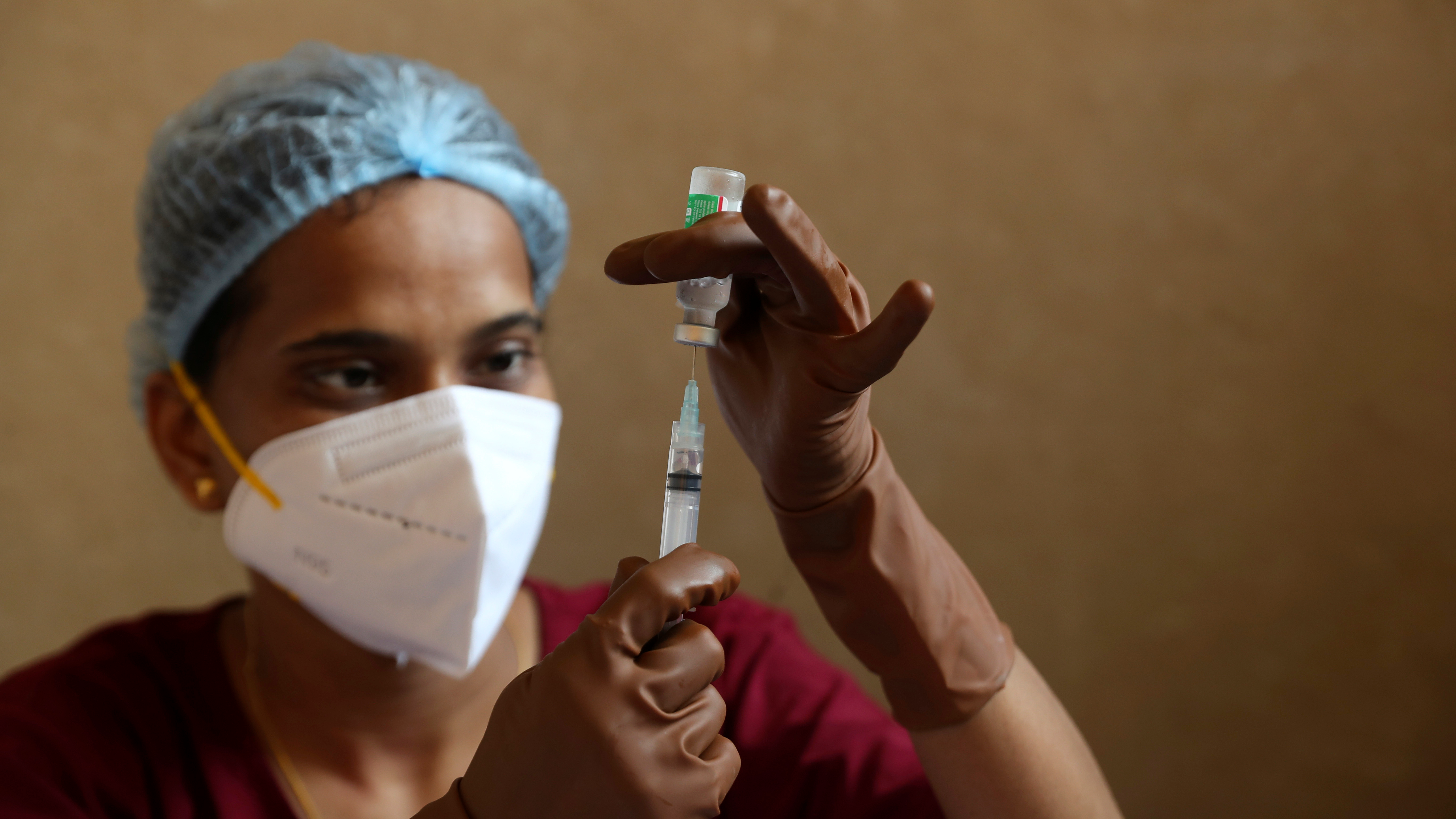 A health worker fills a syringe with a vial of a vaccine during a special inoculation drive for women in Mumbai, India, September 7, 2021. /AP