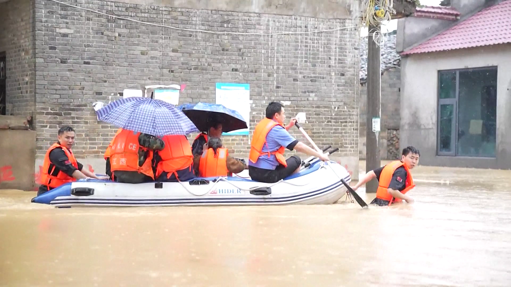 A rescue team evacuating residents trapped by flood in Yichun City, east China's Jiangxi Province, May 5, 2023. /CFP