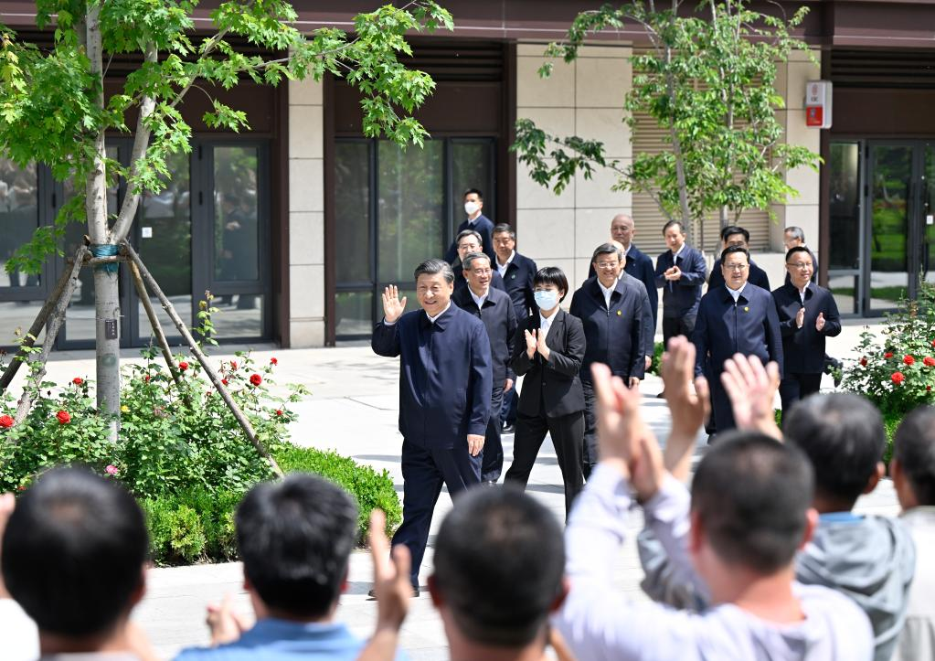 Chinese President Xi Jinping, also general secretary of the Communist Party of China Central Committee and chairman of the Central Military Commission, greets the residents while visiting a residential community in Rongdong District of the Xiong'an New Area, north China's Hebei Province, May 10, 2023. /Xinhua
