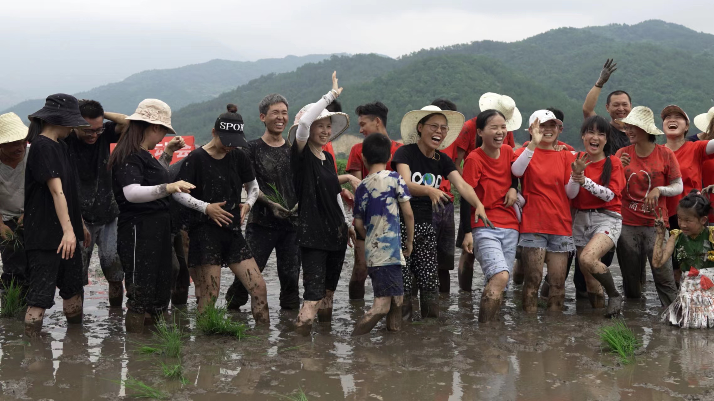 Li Mingpan (sixth from left) and his company staff pose for a group photo after a rice field sports meeting in Huanggang City, central China's Hubei Province, June, 2021. /Courtesy of Li Mingpan