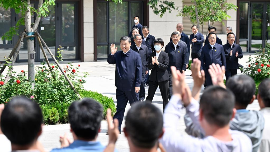 Chinese President Xi Jinping, also general secretary of the Communist Party of China Central Committee and chairman of the Central Military Commission, greets the residents while visiting a residential community in Rongdong District of the Xiongan New Area, north China's Hebei Province, May 10, 2023. /Xinhua
