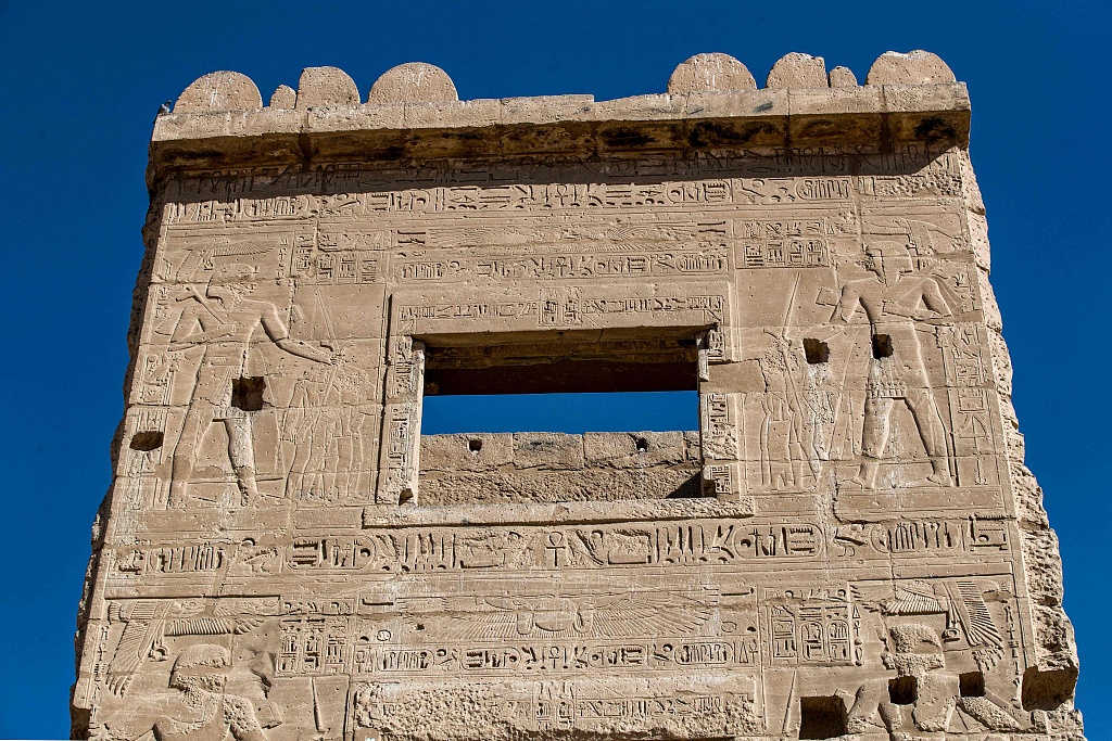 This picture taken on April 10, 2021 shows a view of the relief carvings at the top of the migdol watchtower at the Mortuary Temple of Ramses III in Medinet Habu, Egypt. /CFP