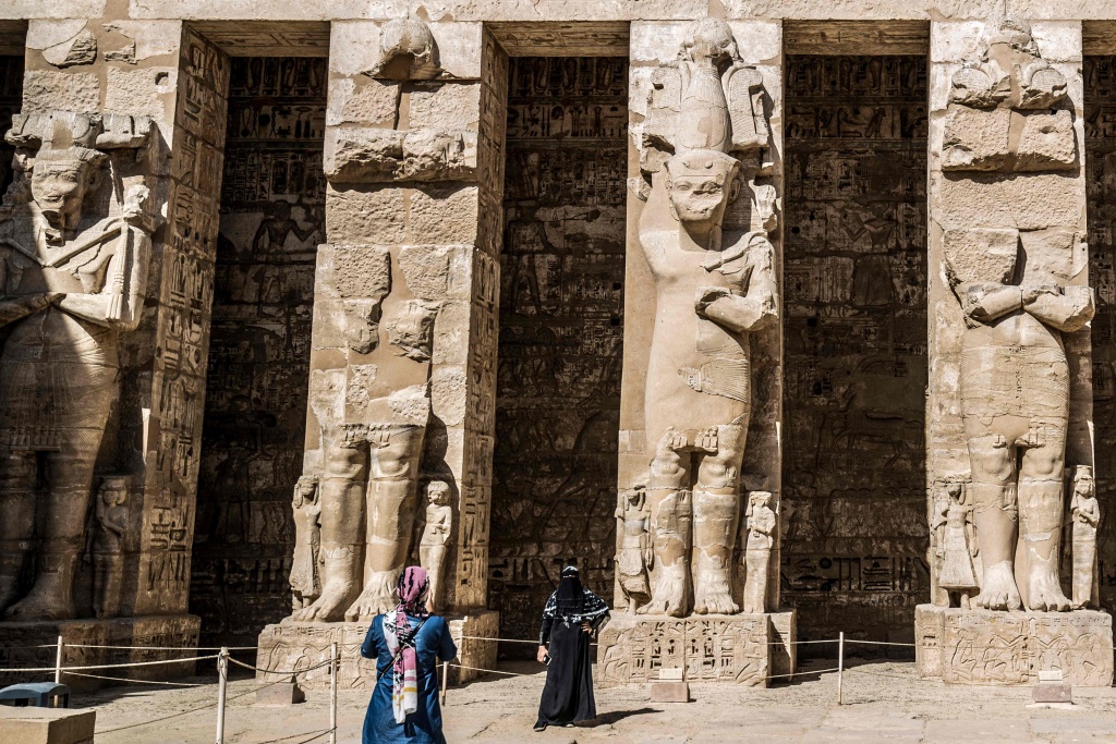 A visitor poses for a picture at the Mortuary Temple of Ramses III in Medinet Habu, Egypt on April 10, 2021. /CFP