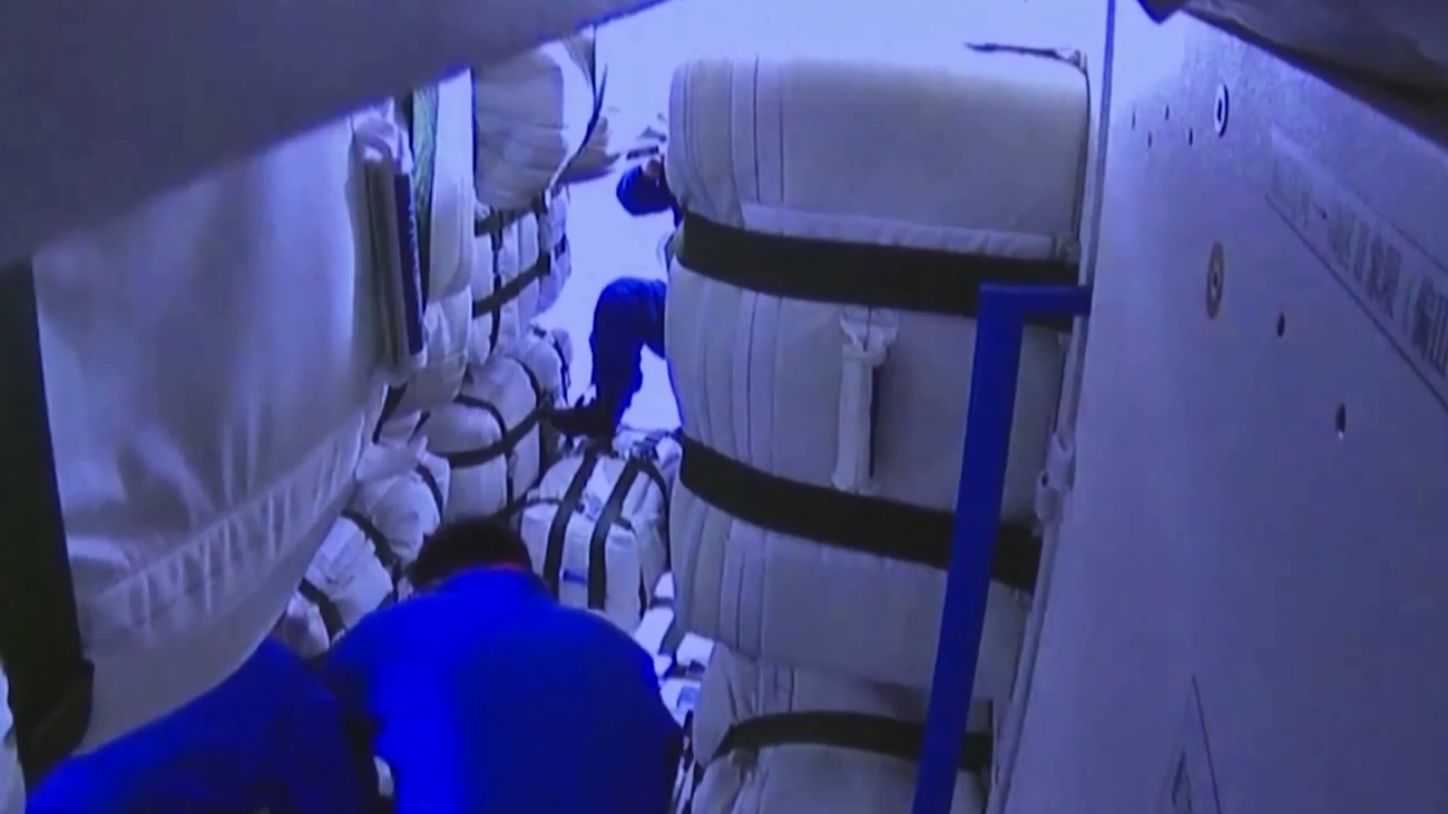 Shenzhou-15 crew moves out packages from Tianzhou-6 cargo craft, May 12, 2023. /CMG