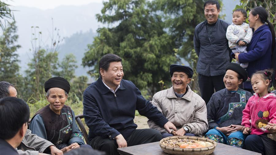 Xi Jinping talks with local villagers and cadres at Shibadong Village in Paibi Township of Huayuan County in the Xiangxi Tujia-Miao Autonomous Prefecture, central China's Hunan Province, November 3, 2013. /Xinhua